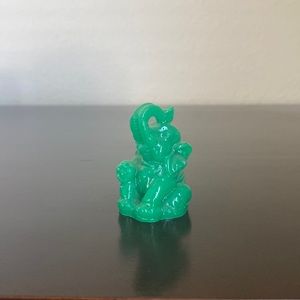 Green figurine elephant with trunk up